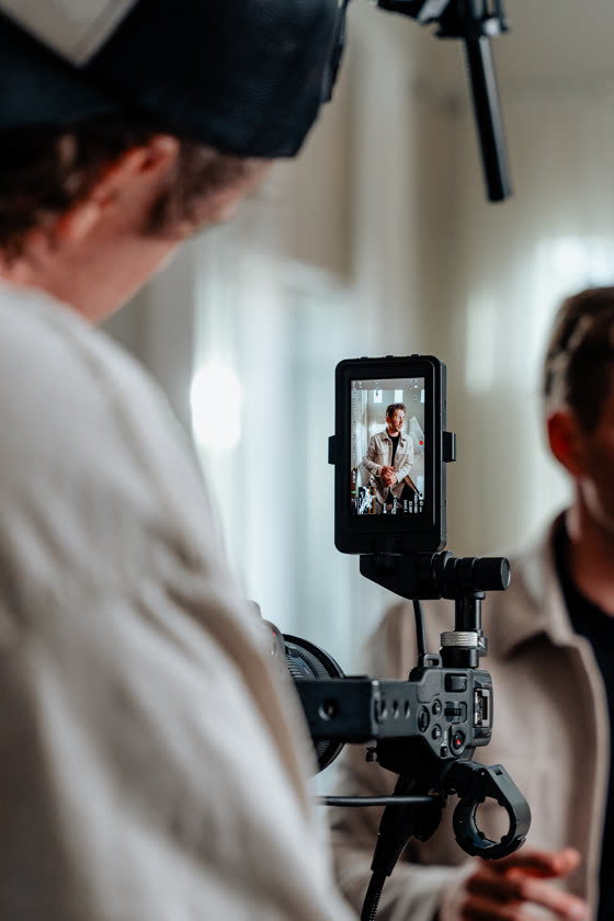 Camera rig framing an interview subject on the monitor during filming