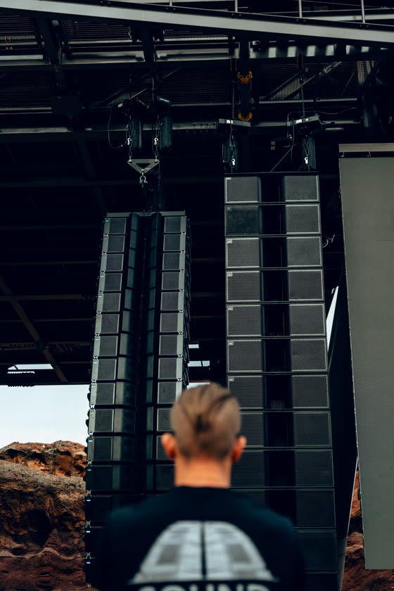 Line array hanging above the stage at an open-air amphitheatre