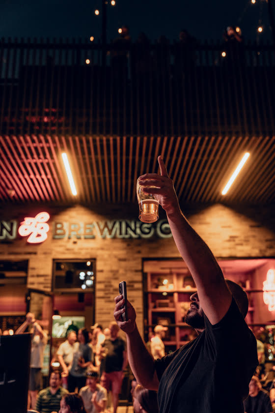 Raising a glass to the crowd outside a Colorado brewery